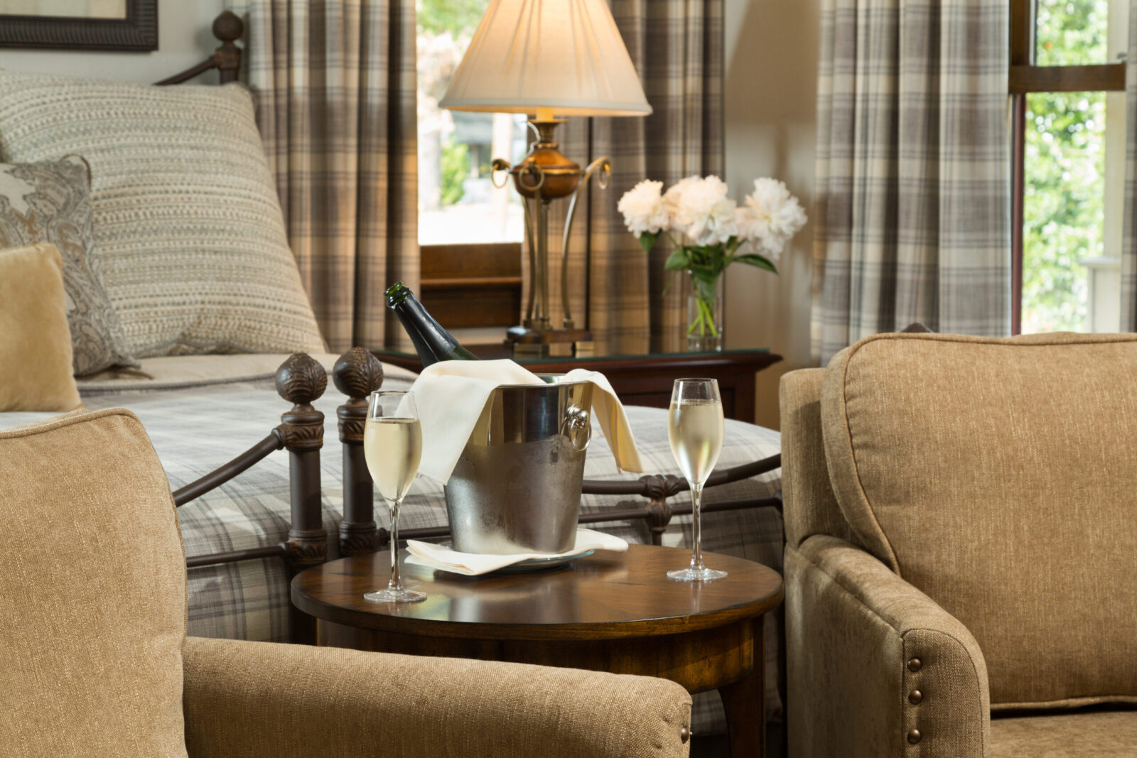 Room with seating area and glasses of wine at our Luxury Hotel in Granbury TX.